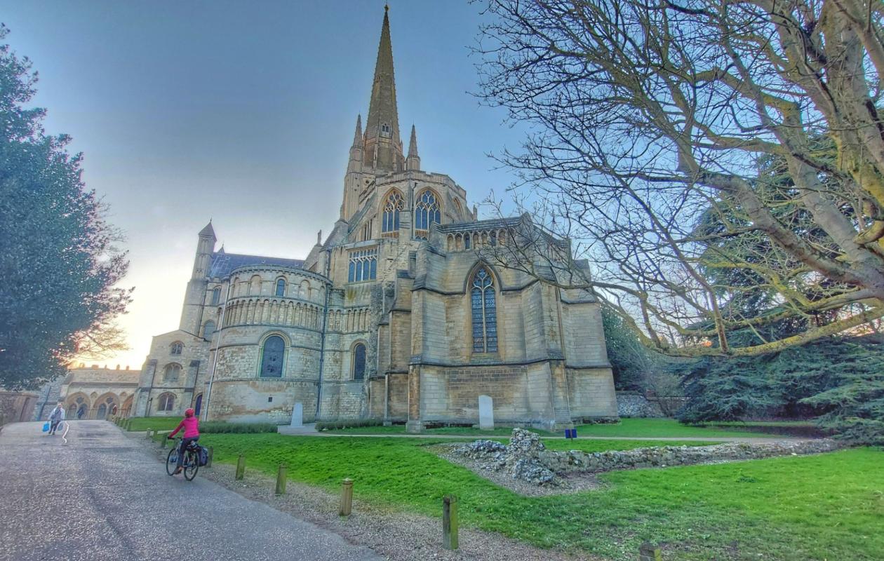 Cycling past Norwich Cathedral