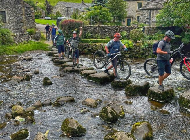 Mountain bikers crossing stream