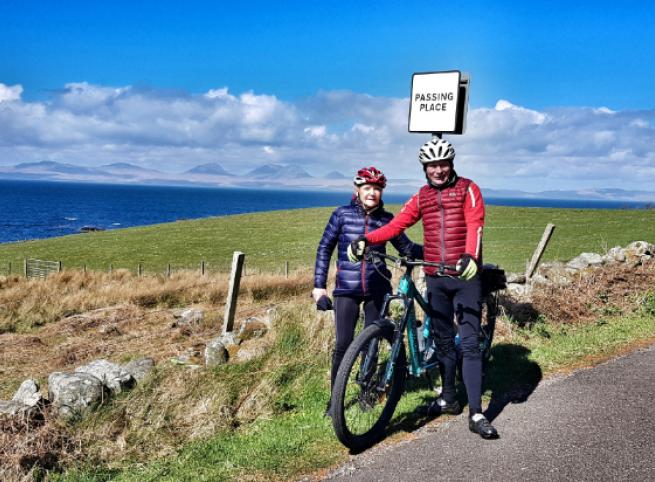 Cycling couple with coastal view