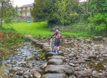 Biker crossing stepping stones