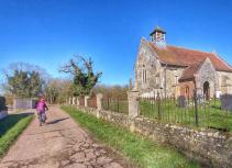 Cycling past a Norfolk Church Rebellion Way