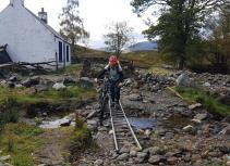 Mountain biker crossing stream