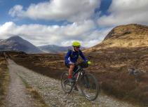 Mountain biker with Glencoe scenery