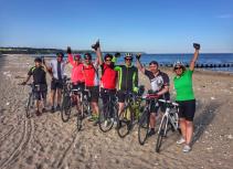 Beach cycling group celebration