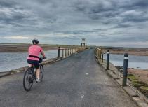 Bicyclist on causeway to Holy Island