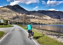 Biking by lake with mountain scenery