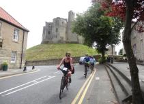 Biking past Warkworth Castle