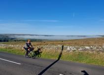 Cyclist in landscape with fog