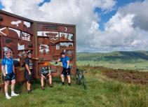 Cyclists at metal monument