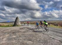 Cyclists with stone monument