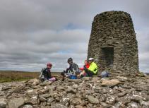 Group biking at stone tower