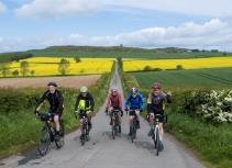 Group cycling countryside spring