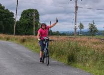 Happy cyclist riding on country road